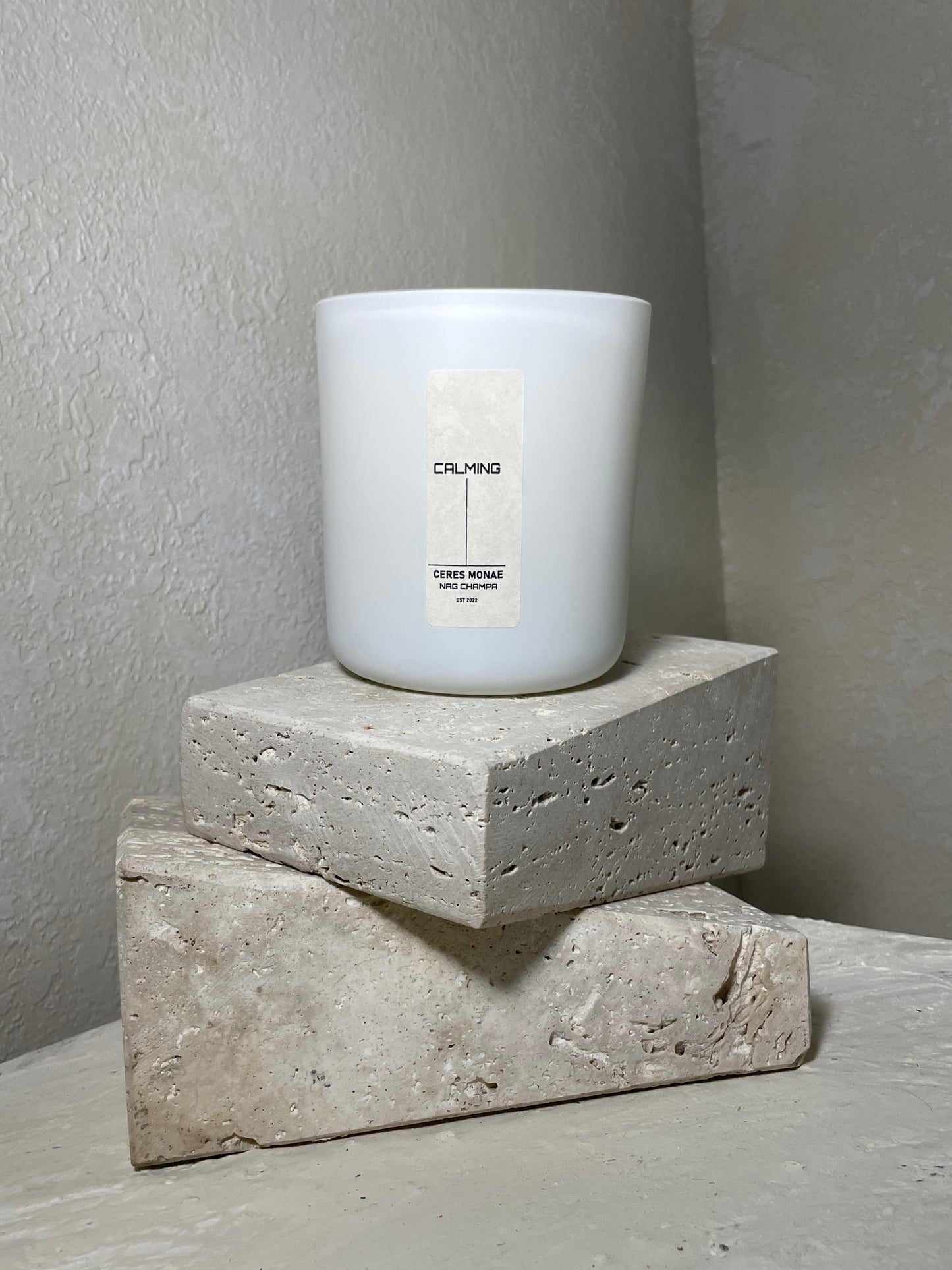 Experience tranquility with Ceres Monae calming candle in the soothing aroma of Nag Champa.